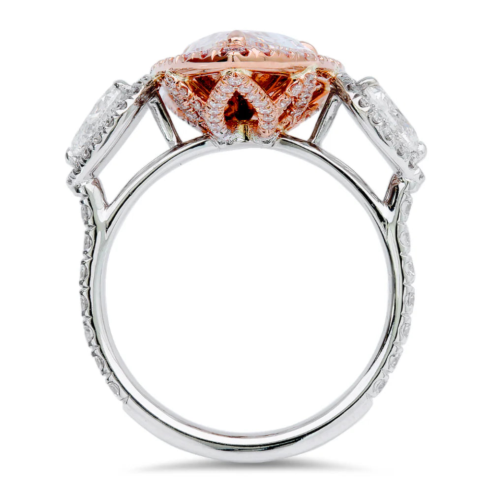 Pink Diamond Halo Ring In 18K White And Rose Gold With 2.82 Carat Total Center Pear-Shaped Pink Diamond, Surrounded By 0.60 Carat Total Round Cut Diamonds, 0.60 Total Carat Side Pear-Shaped Diamonds, And 0.35 Total Carat Pink Round Diamonds