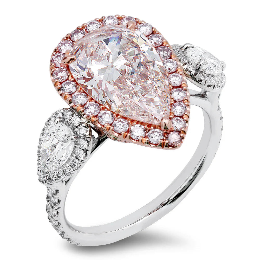Pink Diamond Halo Ring In 18K White And Rose Gold With 2.82 Carat Total Center Pear-Shaped Pink Diamond, Surrounded By 0.60 Carat Total Round Cut Diamonds, 0.60 Total Carat Side Pear-Shaped Diamonds, And 0.35 Total Carat Pink Round Diamonds