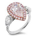Pink Diamond Halo Ring In 18K White And Rose Gold With 2.82 Carat Total Center Pear-Shaped Pink Diamond, Surrounded By 0.60 Carat Total Round Cut Diamonds, 0.60 Total Carat Side Pear-Shaped Diamonds, And 0.35 Total Carat Pink Round Diamonds
